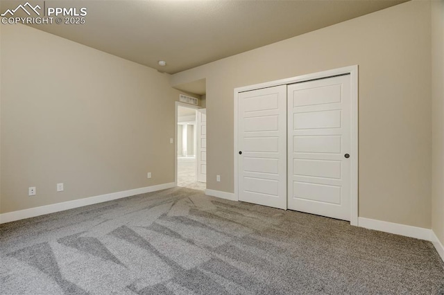 unfurnished bedroom with carpet floors and a closet