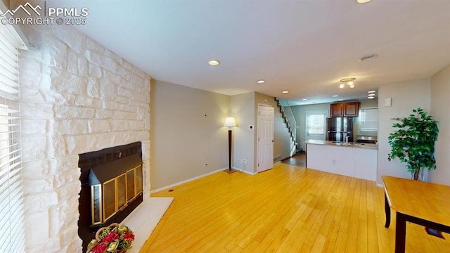 unfurnished living room featuring light wood-type flooring and a fireplace