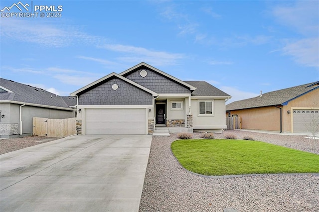 view of front of property featuring a garage, stone siding, fence, and concrete driveway