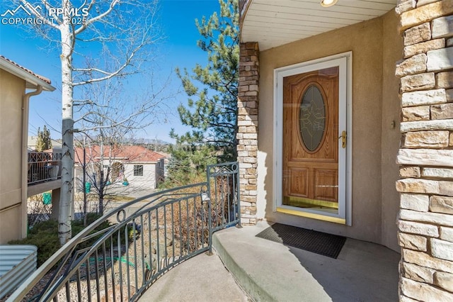 entrance to property with a balcony