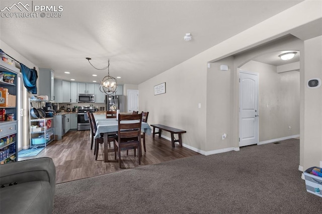 carpeted dining room featuring an inviting chandelier