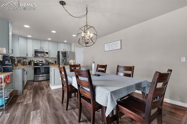 dining room featuring dark hardwood / wood-style flooring and a chandelier