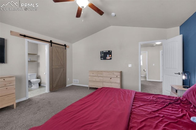 carpeted bedroom featuring connected bathroom, vaulted ceiling, a barn door, and ceiling fan