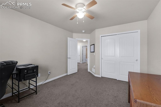 carpeted home office with ceiling fan