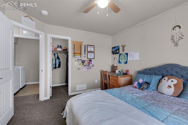 bedroom featuring washing machine and clothes dryer, a spacious closet, dark carpet, a closet, and ceiling fan