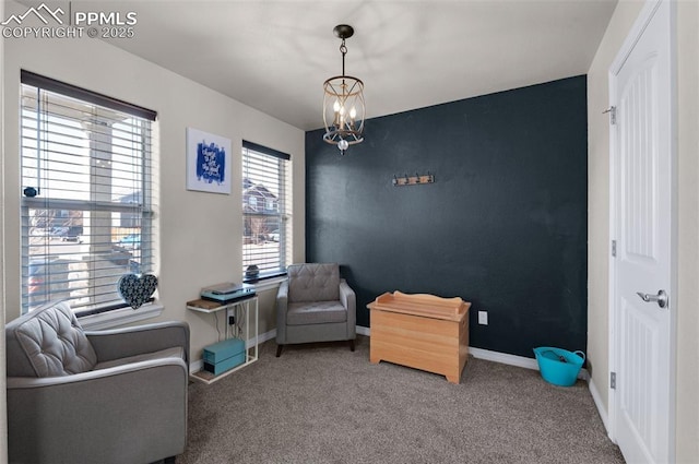 living area featuring a chandelier and carpet floors