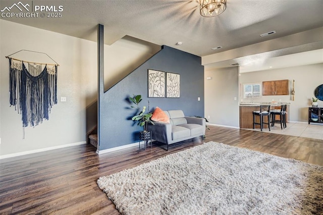 living area featuring hardwood / wood-style flooring and a textured ceiling