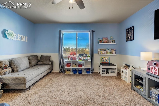 recreation room featuring carpet and ceiling fan