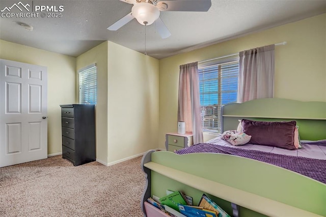 bedroom with multiple windows, light colored carpet, and ceiling fan