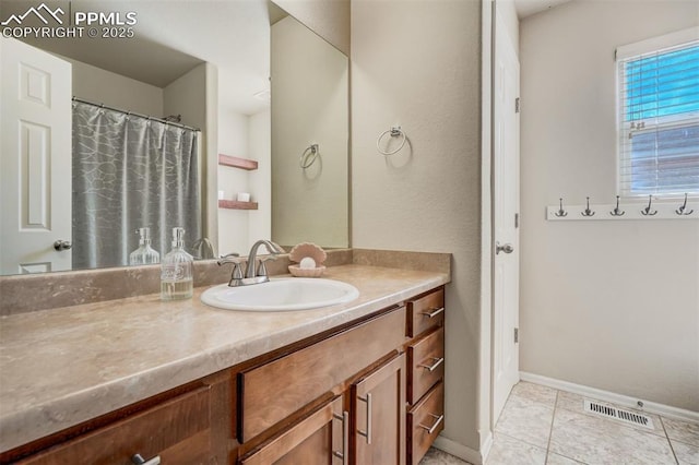 bathroom with tile patterned floors and vanity