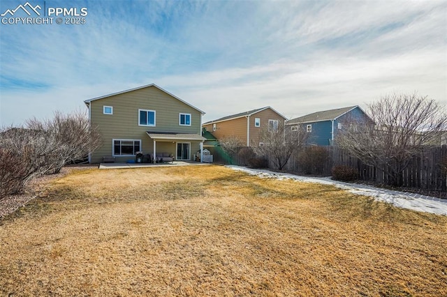 rear view of property with a yard and a patio