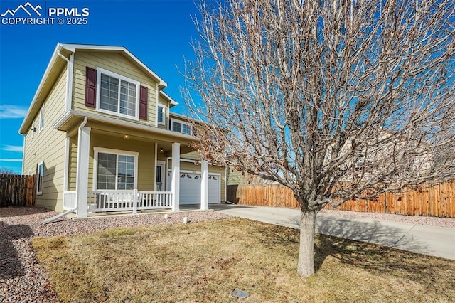 view of front of property with a porch, a garage, and a front yard