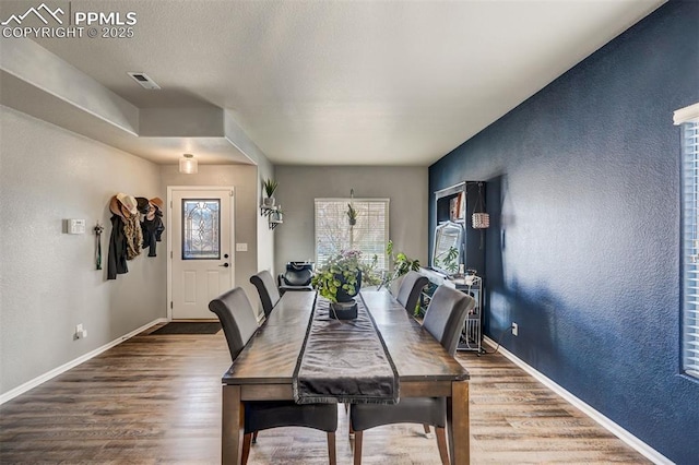 dining space with hardwood / wood-style flooring