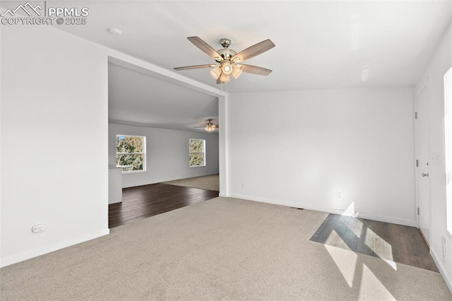 carpeted empty room featuring lofted ceiling and ceiling fan