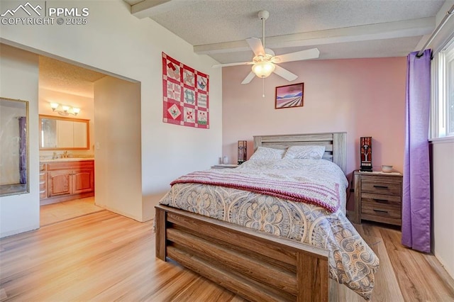 bedroom featuring sink, a textured ceiling, and light hardwood / wood-style flooring