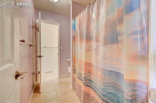 bathroom with walk in shower, toilet, and tile patterned flooring