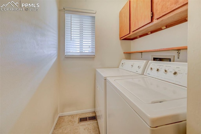 laundry area featuring independent washer and dryer, cabinets, and light tile patterned floors