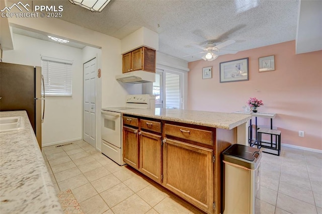 kitchen featuring light tile patterned flooring, white electric range oven, a textured ceiling, stainless steel refrigerator, and ceiling fan