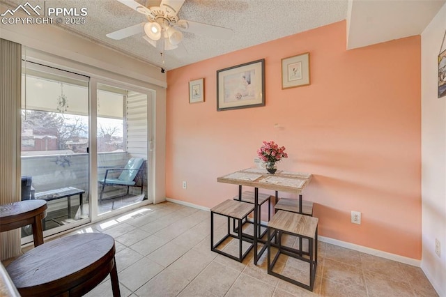 dining space featuring ceiling fan, light tile patterned floors, and a textured ceiling