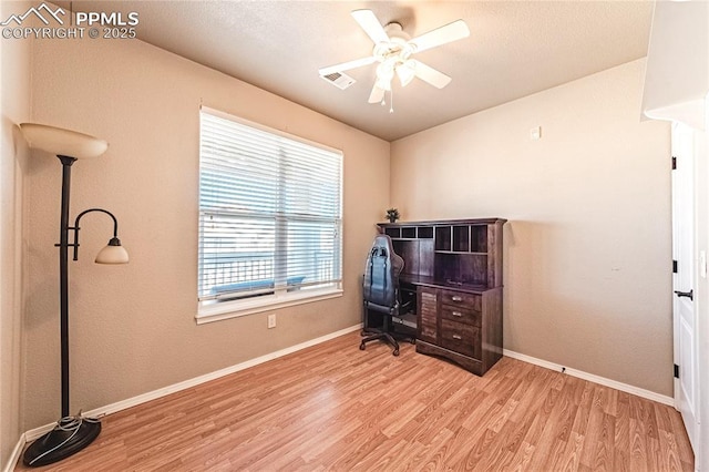 home office with ceiling fan and light hardwood / wood-style flooring