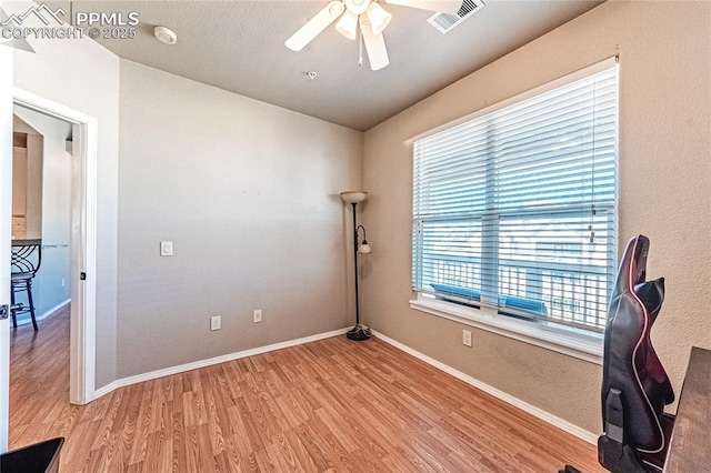 unfurnished office featuring ceiling fan and hardwood / wood-style floors