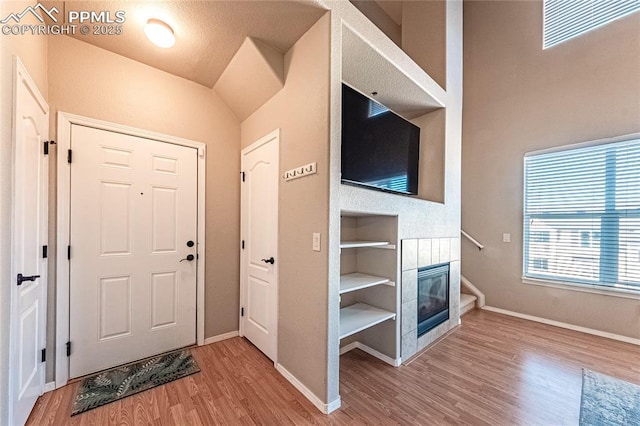 entryway with a fireplace and hardwood / wood-style floors