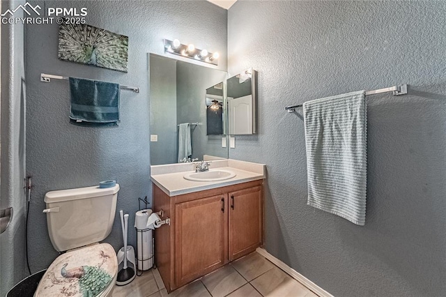 bathroom featuring tile patterned flooring, vanity, and toilet