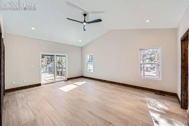 spare room featuring ceiling fan, lofted ceiling, and light wood-type flooring