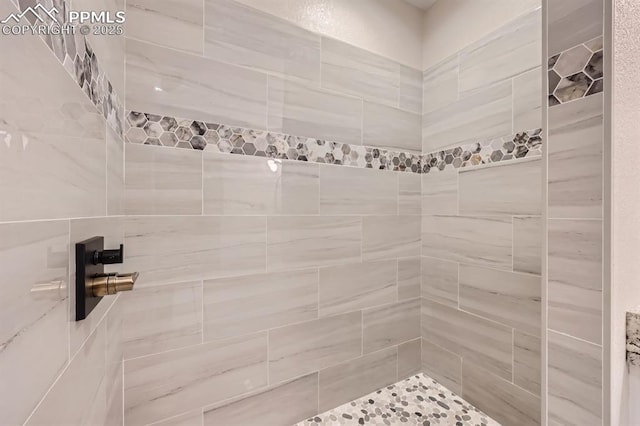 bathroom with tiled shower