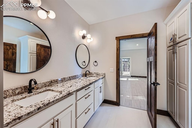 bathroom featuring tile patterned flooring and vanity