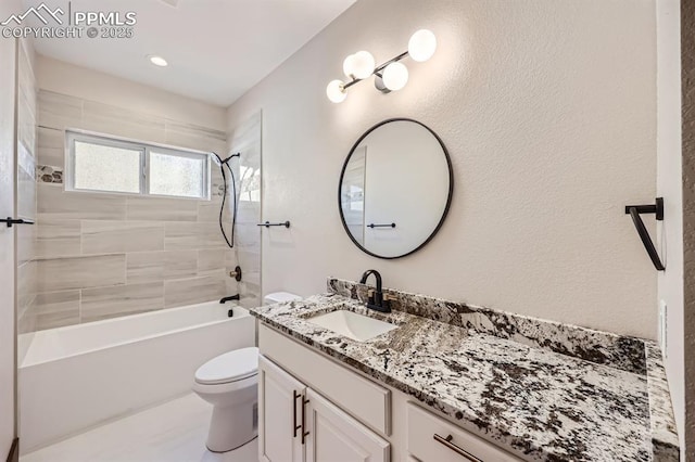 full bathroom featuring tiled shower / bath, vanity, and toilet