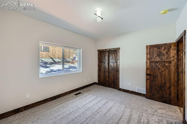 unfurnished bedroom with carpet