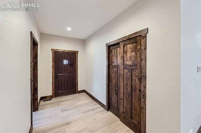 hall with light hardwood / wood-style flooring