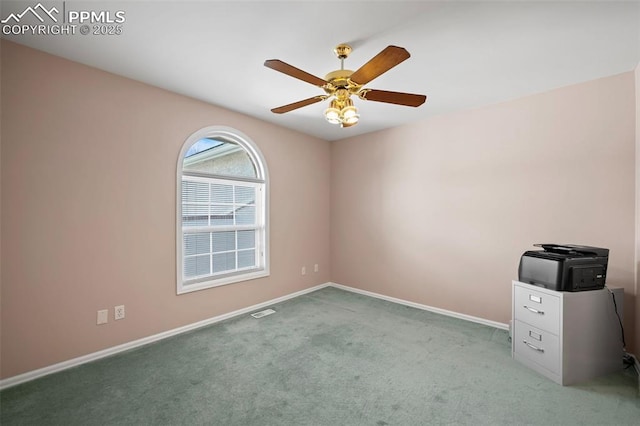 spare room with light colored carpet and ceiling fan