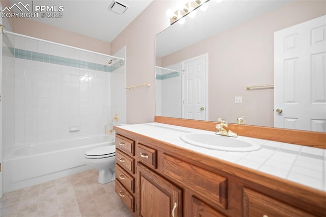 full bathroom with tile patterned floors, vanity, toilet, and tiled shower / bath