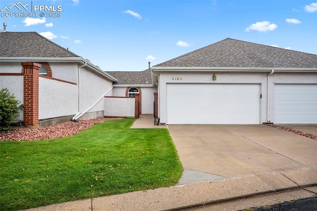 view of front facade with a front yard and a garage