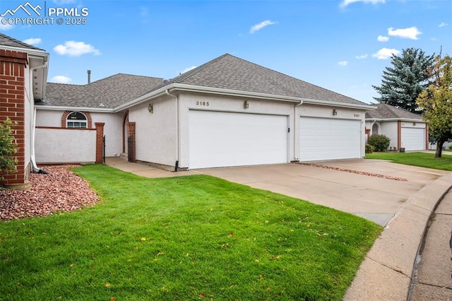 view of front of property featuring a front yard and a garage