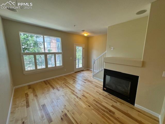 unfurnished living room with wood-type flooring