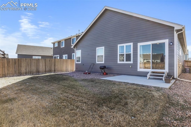 back of property featuring a patio and a yard