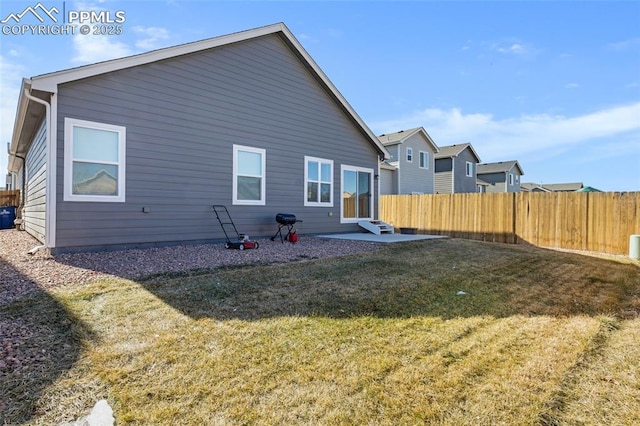 rear view of property with a lawn