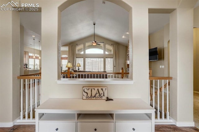 interior space featuring ceiling fan, hanging light fixtures, and white cabinets