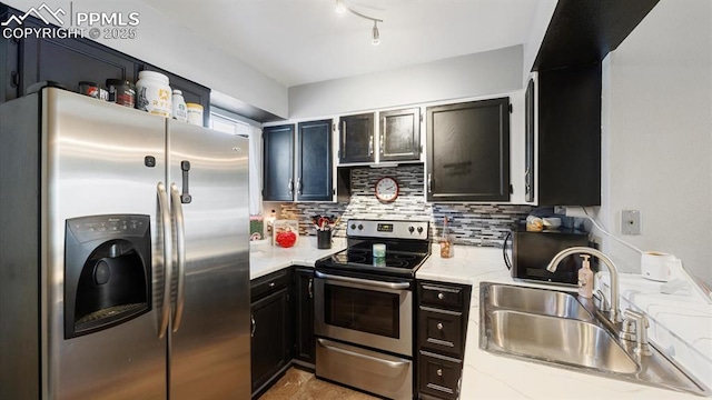 kitchen with stainless steel appliances, sink, backsplash, and light stone counters