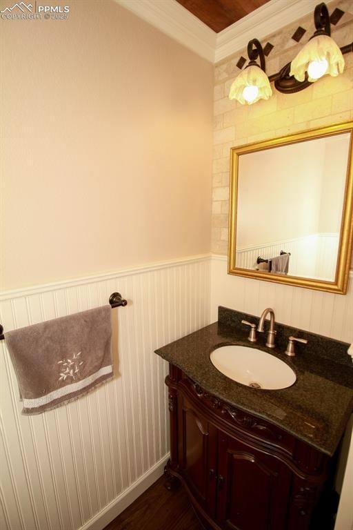 bathroom featuring crown molding, vanity, and wood-type flooring