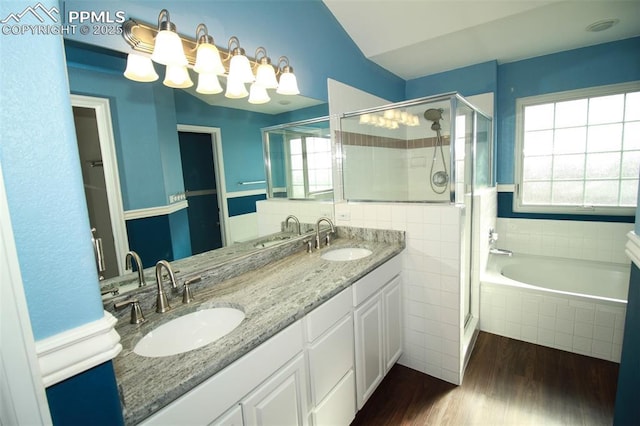 bathroom with wood-type flooring, separate shower and tub, and vanity