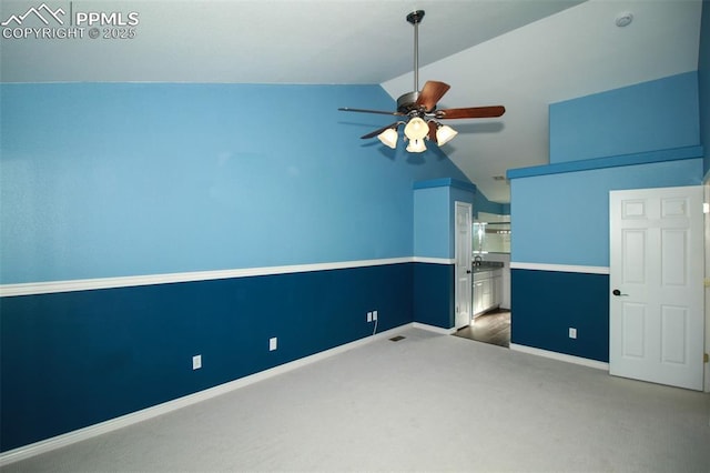 unfurnished bedroom with lofted ceiling, ensuite bath, ceiling fan, and carpet flooring