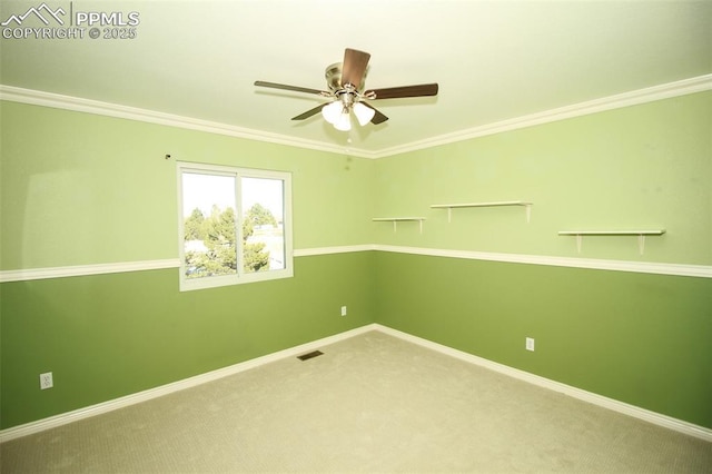 spare room with crown molding, ceiling fan, and carpet