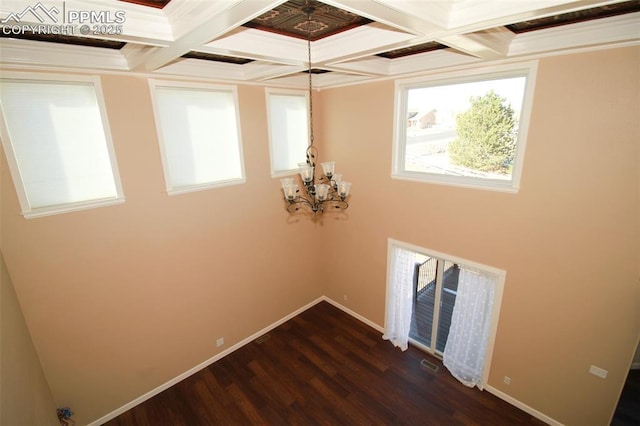 washroom featuring crown molding, dark hardwood / wood-style floors, and an inviting chandelier