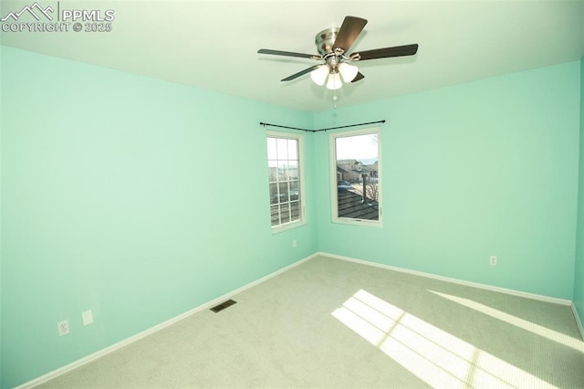 empty room featuring ceiling fan and carpet flooring