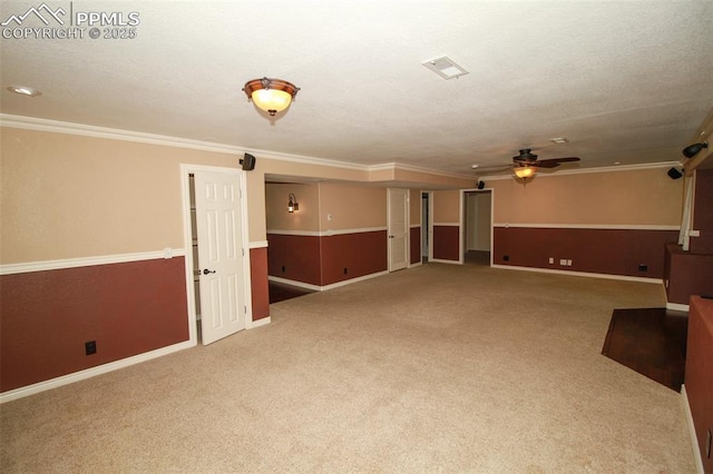 carpeted spare room with ornamental molding and ceiling fan