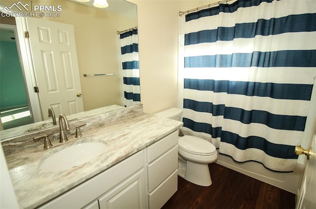 bathroom featuring vanity, hardwood / wood-style floors, and toilet